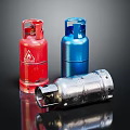 Red Blue And Silver Gas Cylinders As Storage Containers On Black Surface