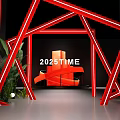 Red Geometric Art Installation With Neon Light Effect Featuring 2023TIME Text And Green Plant Decorations