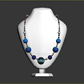 Elegant Fashion Necklace With Blue Green Beads On White Mannequin Against Dark Background
