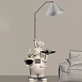 Modern Robot Shaped Floor Lamp With Tray And Green Plant In Living Room