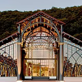 Modern Museum Architecture With Glass Facade Arched Roof And Green Hills