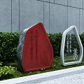 Outdoor Signage With Red And White Frames Near Large Rock Gray Wall And Green Shrubs