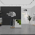 The North Face Clothing Store with Hanging Apparel Poster Display and Green Plants