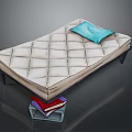 Light diamond quilted mattress with blue pillow and books under transparent box on dark background
