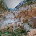 Natural Rock Garden Landscape With Textured Red Gray Stones And Greenery