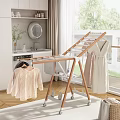 Modern Wooden Clothes Drying Rack With Wheels And Hanging Garments In Laundry Area