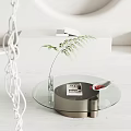 Modern Round Glass Coffee Table With Green Plant In Transparent Vase DWELL Magazine And White Dish