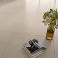 Light Colored Floor Tiles With White Flowers Vase And Stacked Magazines On Interior Floor