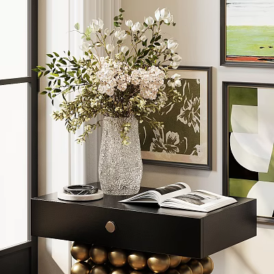 Elegant Vase With Fresh Flowers On Black Side Table With Open Magazine And Decorative Paintings 3d model
