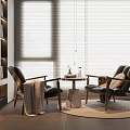 Casual Sofa Set With Black Leather Armchairs Round Coffee Table Blanket And Fireplace Background