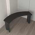 Black Curved Side Table With Modern Design On Wooden Floor And White Walls