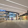 Modern Spacious Bright Shopping Mall Lobby With Ceiling Lights Retail Stores Escalators And Shoppers