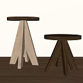 Two Wooden Stools With Round Seats Three Legs Light And Dark Wood Tones On Wooden Floor