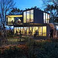 Modern Container Building With Open Design Trees and People Gathering in Evening Lighting