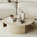 Modern Round Beige Marble Coffee Table With Books Vase And Beige Sofa