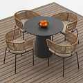 Outdoor Rattan Sofa with Light Cushions Wooden Floor and Round Table with Oranges