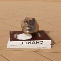 Chanel Themed Books With Silver Metallic Mask On Wooden Floor Surface