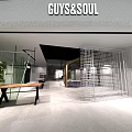 GUYS&SOUL Modern Clothing Store Interior With Green Plant Metal Grid Screen And Wooden Table