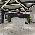 Modern Ducati Reception Area With White Reception Desk Geometric Backdrop Green Plants And Motorcycle Posters