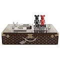 Elegant Patterned Leather Coffee Table With Glass Top Brass Accents And Decorative Figurines