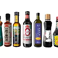 Various Condiment Bottles With Colorful Labels And Diverse Designs Arranged Neatly
