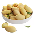 White ceramic bowl filled with fresh ripe mangoes and green leaves
