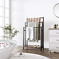 Stylish Black Metal Towel Rack In Modern Bathroom With Decorative Towels Slippers And Green Plant