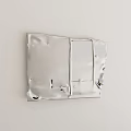 Silver Metal Decorative Panel With Irregular Edges Wrinkles Holes On White Wall