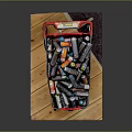 Black Shopping Cart Filled With Various Food And Drink Bottles On Wooden Dark Mat