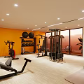 Modern Home Gym Interior With Orange Walls Floor to Ceiling Windows And Fitness Equipment