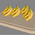 Golden Bananas Arranged in Three Bunches on Light Wooden Tray