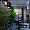 Luxurious Villa Balcony Space With Outdoor Seating Green Plants And Decorative Lights