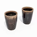 Two Rustic Dark Brown Ceramic Vessels With Cylindrical Shape And Textured Surface