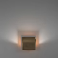 Modern Brass Wall Lamp Mounted On White Wall With Warm Light And Sleek Design