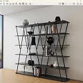 Modern Geometric Black Bookshelf With Multiple Shelves Holding Books And Decorative Vases
