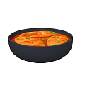Orange Fish Fillets in Black Bowl with Red Broth Chili Peppers and Cilantro Garnish