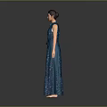 Woman in Dark Blue Sequined Long Dress with Belt Standing Against Gray Background