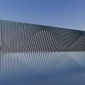 Modern Metallic Striped Background Wall With Reflective Surface And Architectural Design