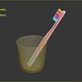 Children's Toothbrush With Yellow Handle Green Bottom Brown Bristles In Glass Cup