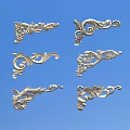 Silver Ornate Carved Decorations With Various Intricate Floral And Curved Patterns