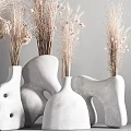 White Ceramic Vases With Various Shapes Holding Dried Pampas Grass And Pink Blossoms