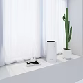 LEVOIT Air Purifier on Windowsill in White Room with Cactus Tray Cups and Mobile Phone