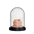 Colorful Decorated Cake With Pastel Frosting Under Clear Glass Dome On Black Base