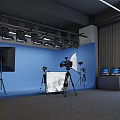 Professional Photography Studio Setup With Blue Backdrop Lighting Cameras And Monitors