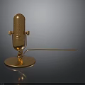 Golden Microphone With Stand Base And Extended Cable On Dark Background