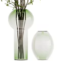 Transparent Glass Vases Holding Green Foliage and Small White Flowers for Home Decor
