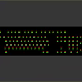 Black Computer Keyboard With Green Backlit Keys And Red Accent Details