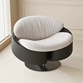 Modern Curved Lounge Chair With White Upholstered Cushion And Black Circular Base