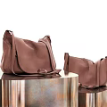 Fashionable Brown Leather Crossbody Bags Showcased On Sleek Metal Display Stands