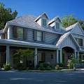 Single Family House With Gray Roof White Siding Shutter Windows Porch Columns And Greenery